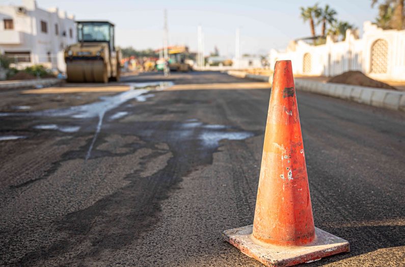 close-up-orange-traffic-cone-road-copy-space_optimized